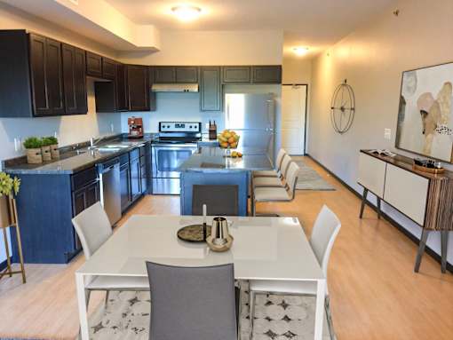 A modern kitchen with a dining table and chairs.