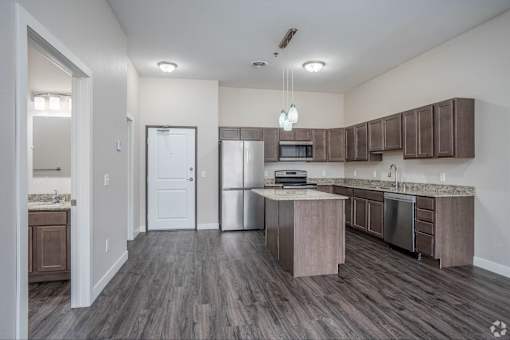 A kitchen with a white door and a counter.