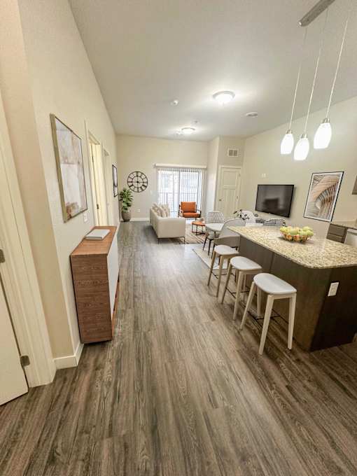 A modern living room with a bar area and a television.