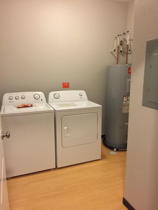 Two washing machines in a laundry room.