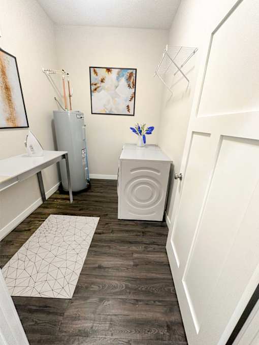 A small room with a white table and a white cabinet.