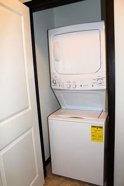 A white dishwasher is in a dark room.