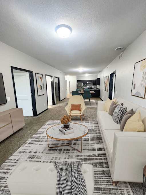 A living room with a white couch and a coffee table.