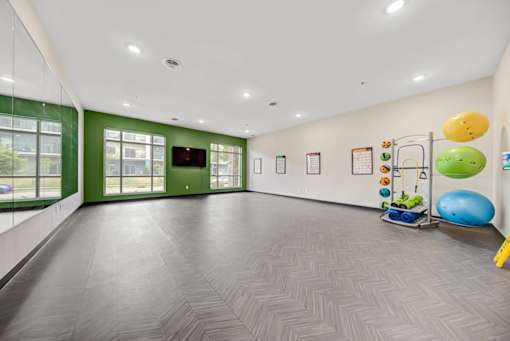 A room with a grey floor and a green wall.