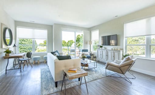 A living room with a white couch and a wooden coffee table.