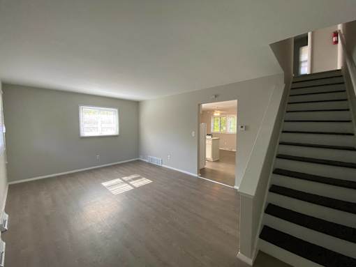 A room with a staircase leading to another room at Root River Apartments, Wisconsin 53129