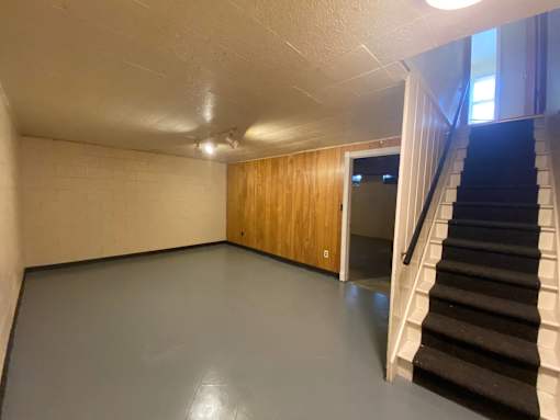 A room with a staircase leading to another room at Root River Apartments, Greendale, WI
