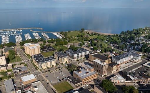 A cityscape with buildings, roads, and a marina.