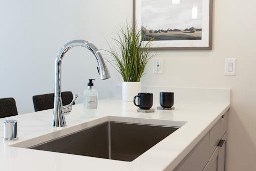 A modern kitchen with a sink at Alta Apartments, Wisconsin 53186