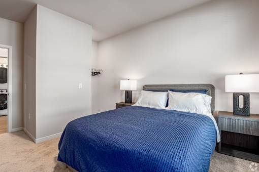 A bedroom with a large bed and two lamps at Bloom, Monona, WI, 53716