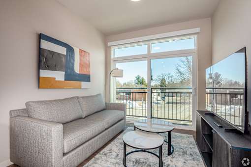 A grey couch sits in a living room with a television at Bloom, Wisconsin, 53716