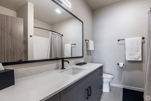 A bathroom with a white countertop and a black faucet at Bloom, Monona, Wisconsin