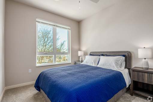 A bedroom with a large bed and a window at Bloom, Monona