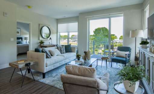 A living room with a couch, chairs, and a coffee table.