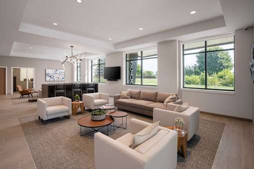 A spacious living room with a large window and a flat screen TV.