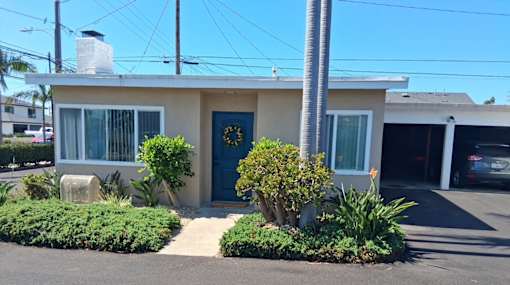 A house with a blue door and a garage.