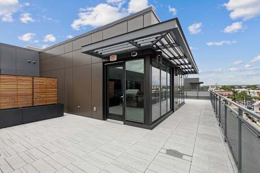 A modern building with a glass entrance and a metal railing.