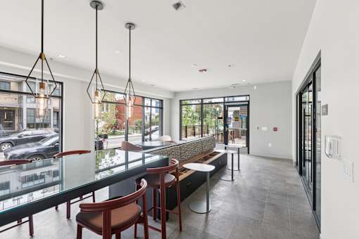 A modern interior with a glass table and chairs.
