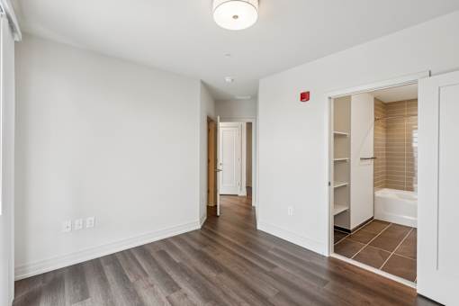A room with a white wall and a wooden floor.