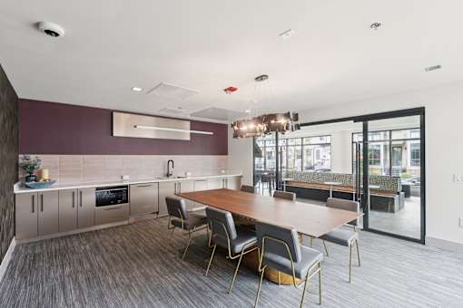 A modern kitchen with a dining table and chairs.