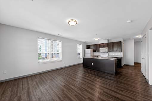 A kitchen with a wooden floor and a window.