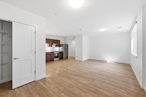 A room with wooden floors and white walls.