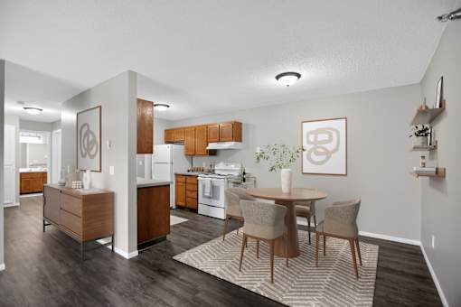 A modern kitchen with a dining table and chairs.