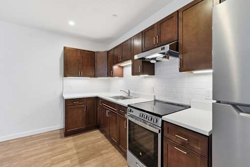 A kitchen with wooden cabinets and stainless steel appliances.