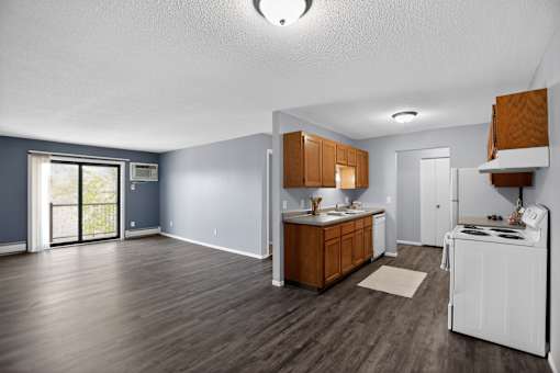 A kitchen with wooden cabinets and a white stove top oven.