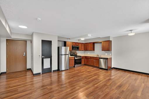 A kitchen with wooden floors and white walls.