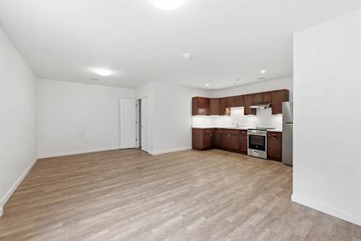 A kitchen with wooden floors and white walls.