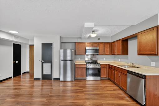 A kitchen with wooden cabinets and stainless steel appliances.