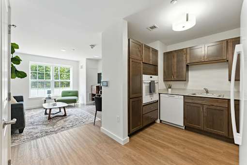 A kitchen with wooden cabinets and a white dishwasher.