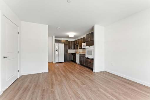 A kitchen area with a refrigerator, microwave, and oven.