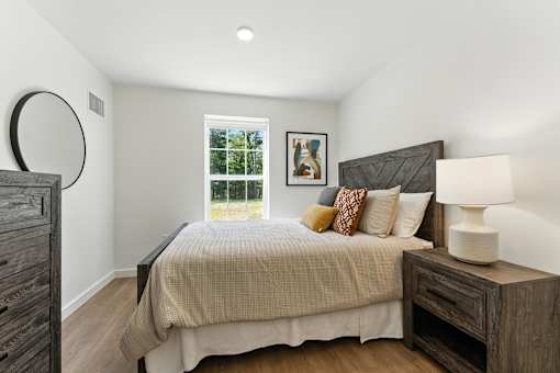A bedroom with a large bed and a window.