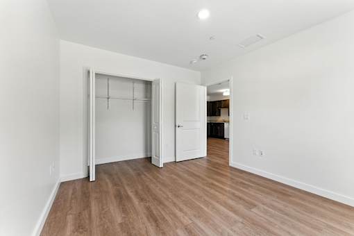 A room with a white door and a white wall.