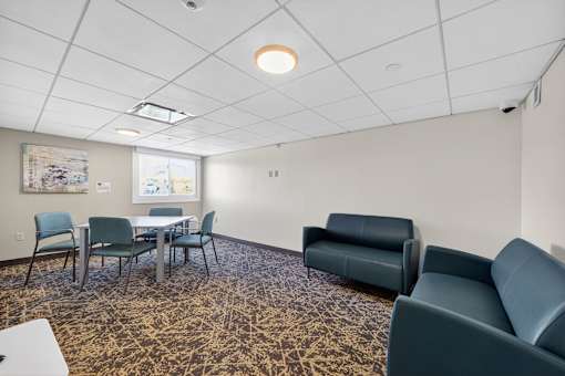 A conference room with a table and chairs.