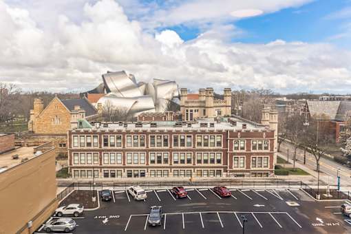 A modern building is situated in front of a traditional building.