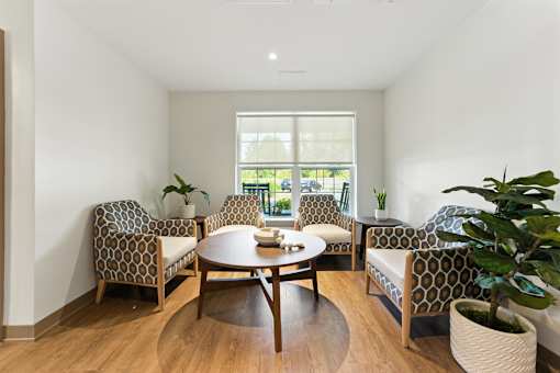 A living room with a table and chairs.