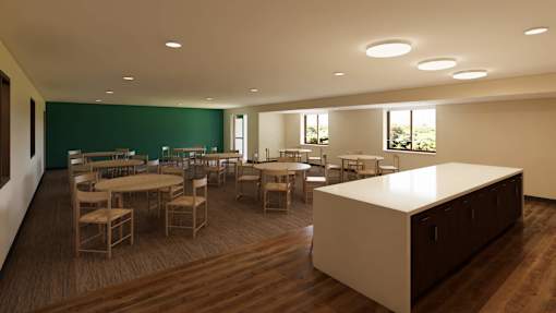 A room with a long table and chairs.