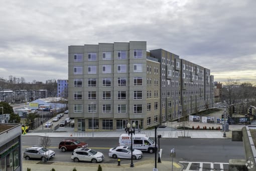 a large building in the middle of a street with cars