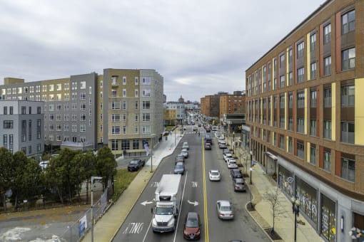 a busy city street filled with cars and tall buildings