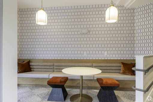 a seating area with a table and two lamps