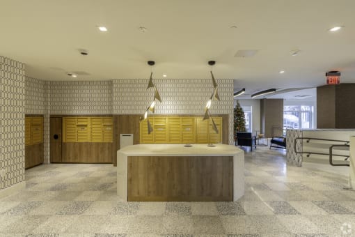 the lobby of an office building with a reception desk and yellow cabinets