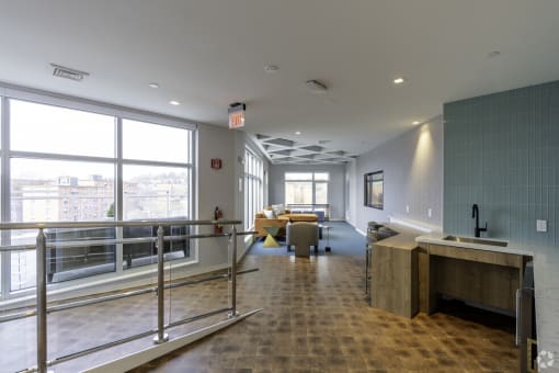 the lobby of a building with a reception desk and large windows