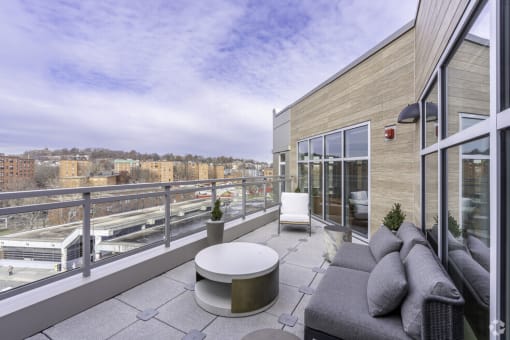 a balcony with a city view and a couch and a table