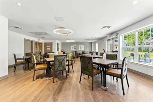 A conference room with a long table and chairs.