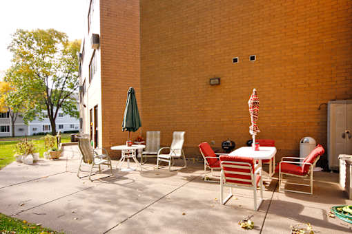 A patio with a table and chairs.