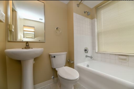 A white toilet sits next to a sink in a bathroom.