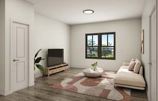 A living room with a flat screen TV and a large window.